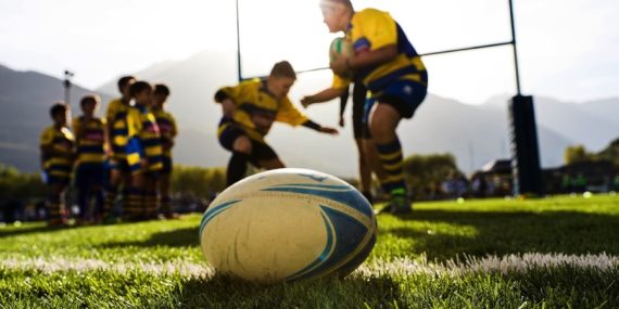 Rugby ball with team in background
