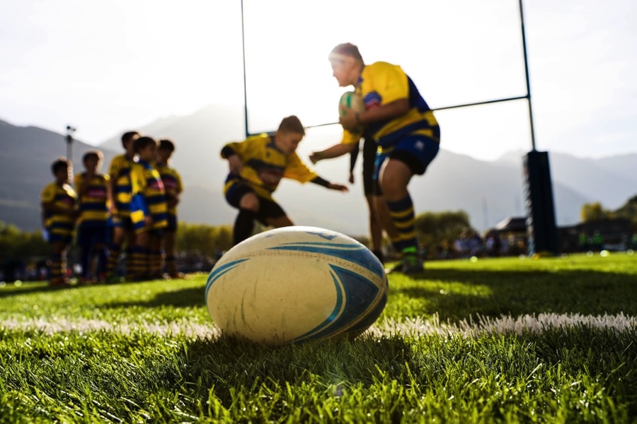 Rugby ball with team in background